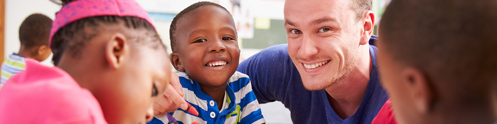 Little Boy Smiling with Staff Member
